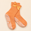 Maison Joie The Original orange grip socks with satin bows and scalloped cuffs