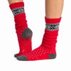TAVI Stacy Festive slouch grip socks – red holiday pattern and sole view