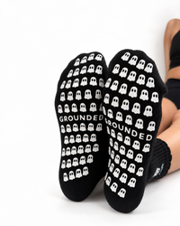 Black crew grip socks with white ghost embroidery and ruffled cuff