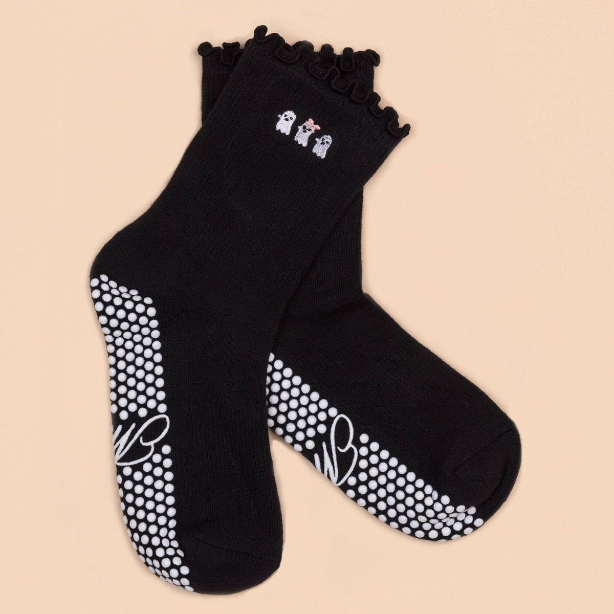 Black ruffle grip socks with three embroidered ghosts and white dot soles