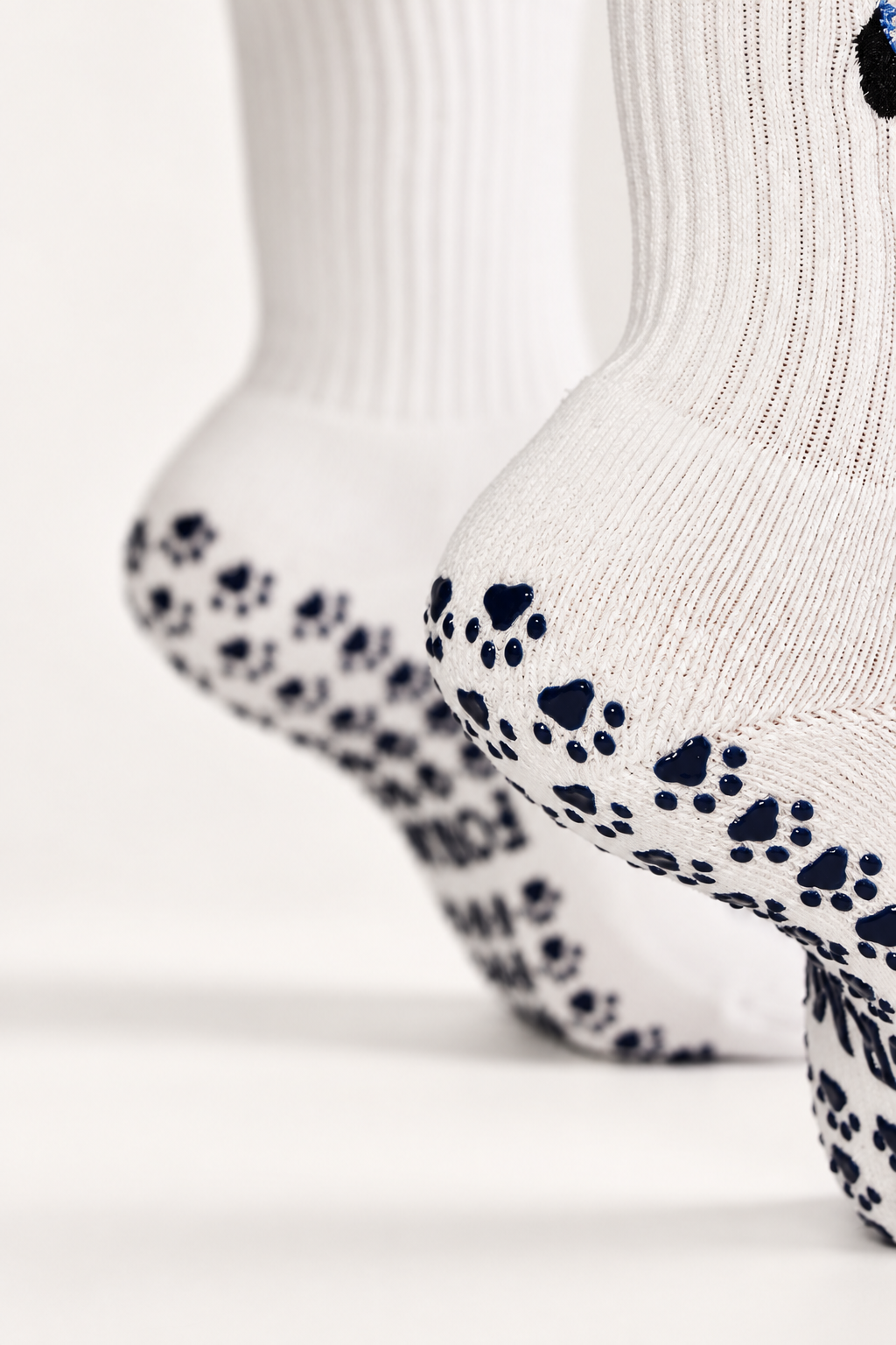 Doxie Darling grip sock sole with navy paw-print non-slip grips