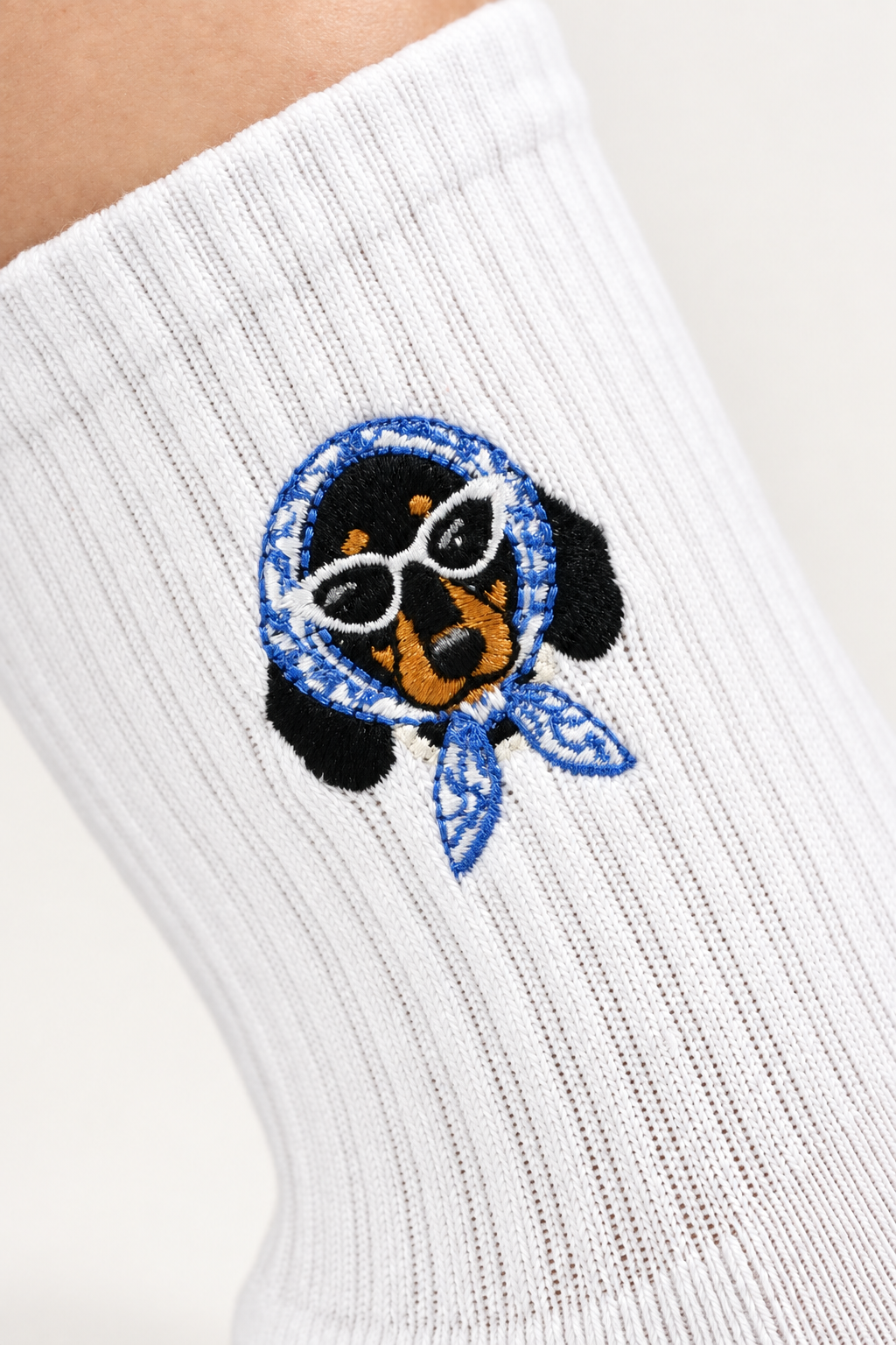 Doxie Darling grip socks worn with embroidered dachshund detail at the ankle
