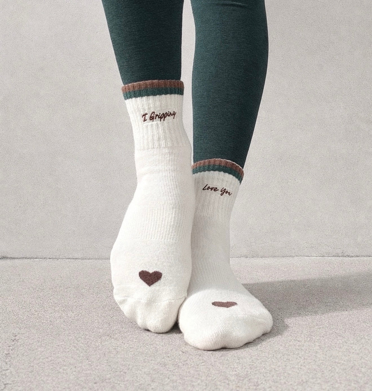 I Gripping Love You socks showing embroidered toe hearts and green sole grips