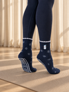 Pilates People Winter Wonderland dark blue grip socks with snowflakes, snowmen and white scalloped cuff — view 1