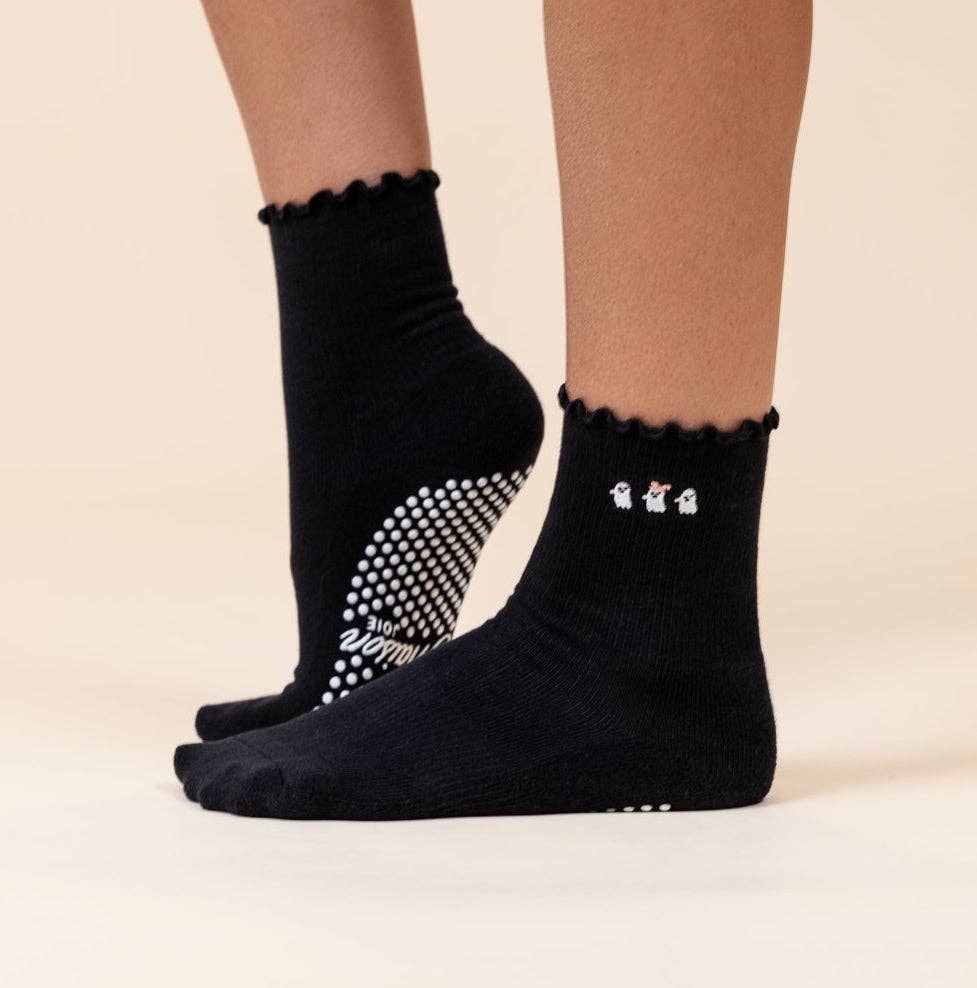 Maison Joie Ghost Ruffle black grip socks worn with white traction