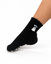 Ghost-shaped non-slip grips on black Grounded studio socks