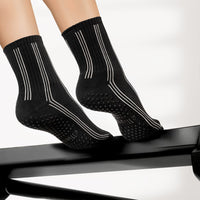 Elliosa Pinstripes Black grip socks on a Pilates reformer