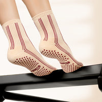 Elliosa Pinstripes Burgundy Caramel grip socks on a Pilates reformer