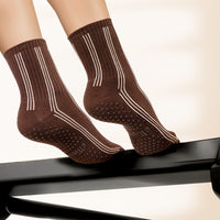 Elliosa Pinstripes Espresso grip socks on a Pilates reformer