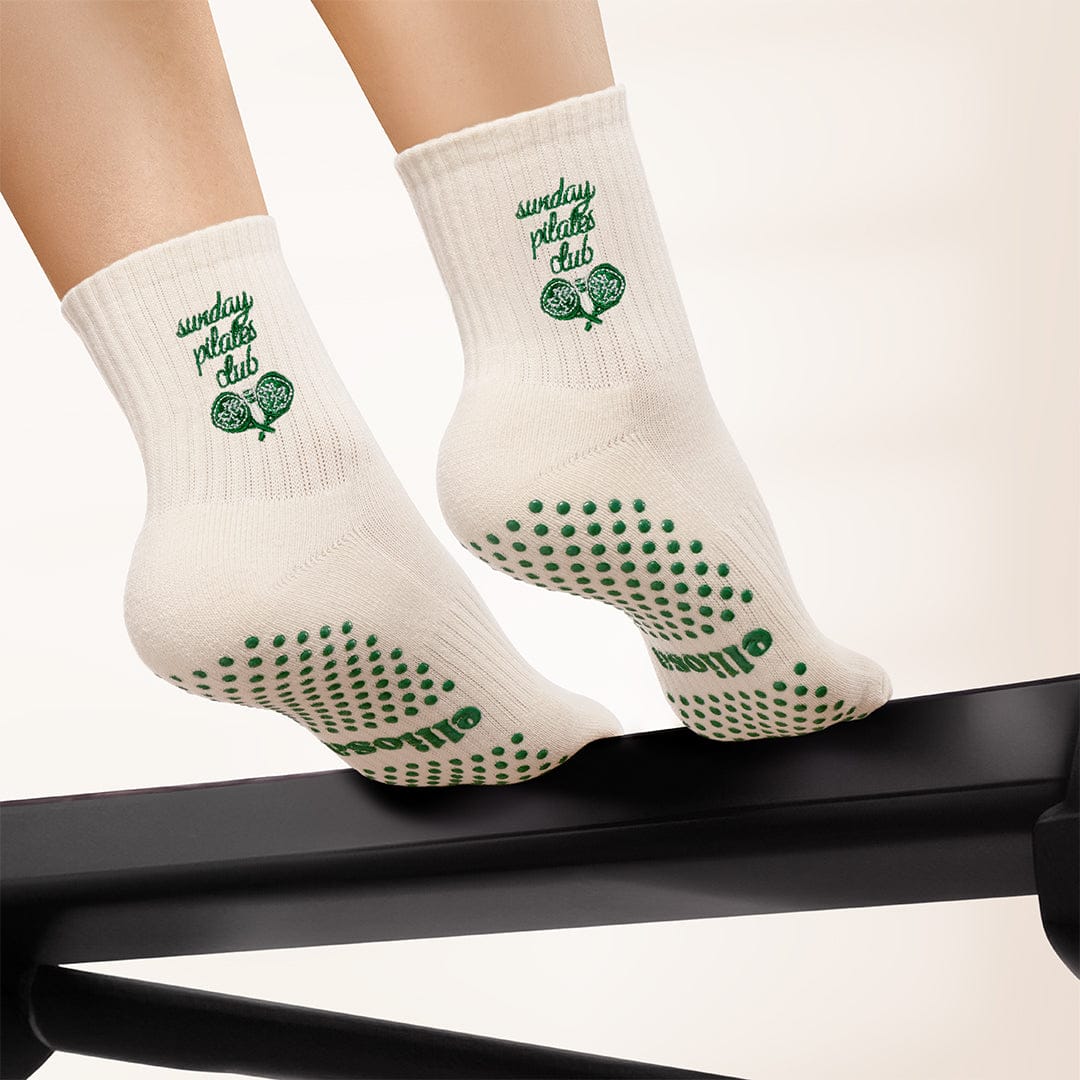 Sunday Pilates Club grip socks worn on a Pilates reformer