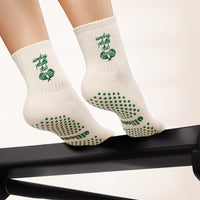 Sunday Pilates Club grip socks worn on a Pilates reformer