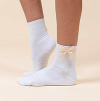 Maison Joie The Signature Peach grip socks worn, showing peach bow and white grips
