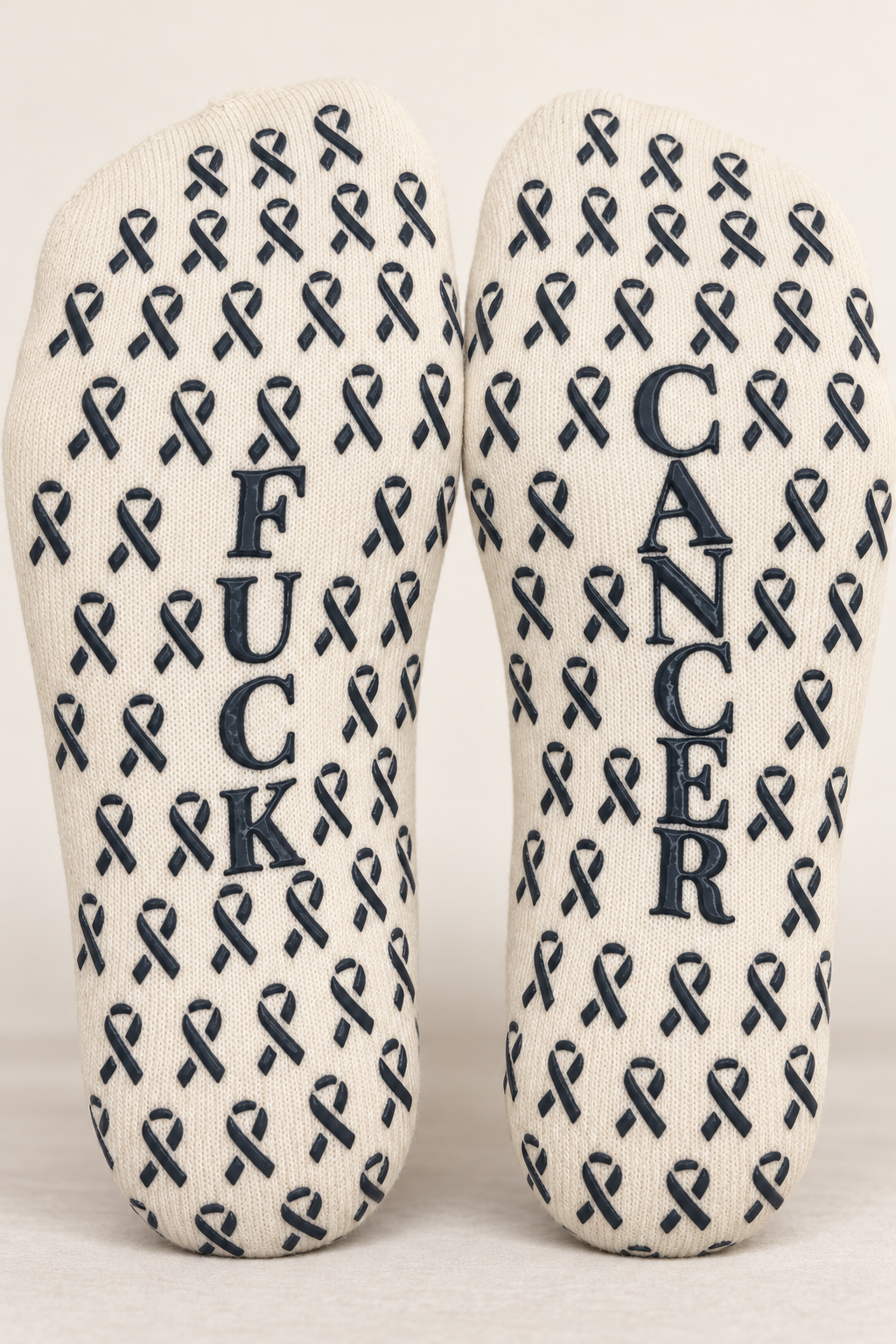 Close view of Fuck Cancer ribbon grip pattern on cream crew socks