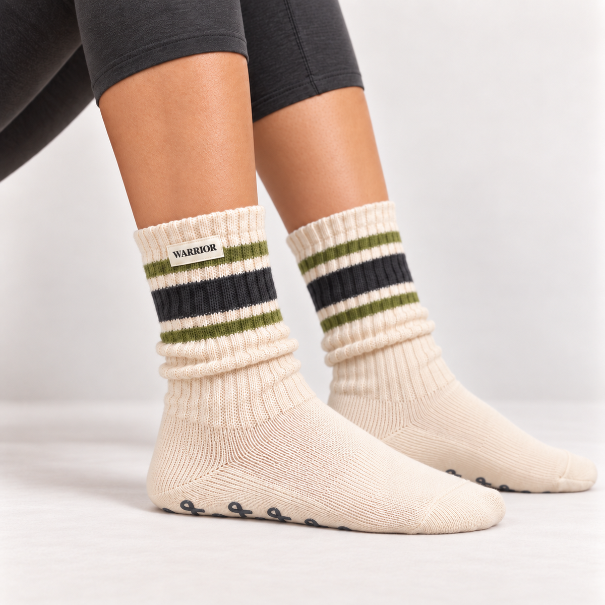 Linda's Warrior cream crew grip socks with green and charcoal stripes worn on a model