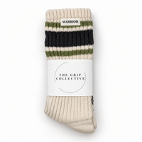 Linda's Warrior cream crew grip socks with WARRIOR label and green charcoal stripes