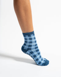The Prep blue gingham grip sock worn in a crew silhouette