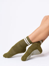 Olive and Cream Stripe quarter grip socks ankles crossed
