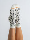 Animal Print Black quarter grip socks on feet