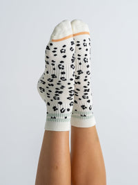 Animal Print Black quarter grip socks on feet