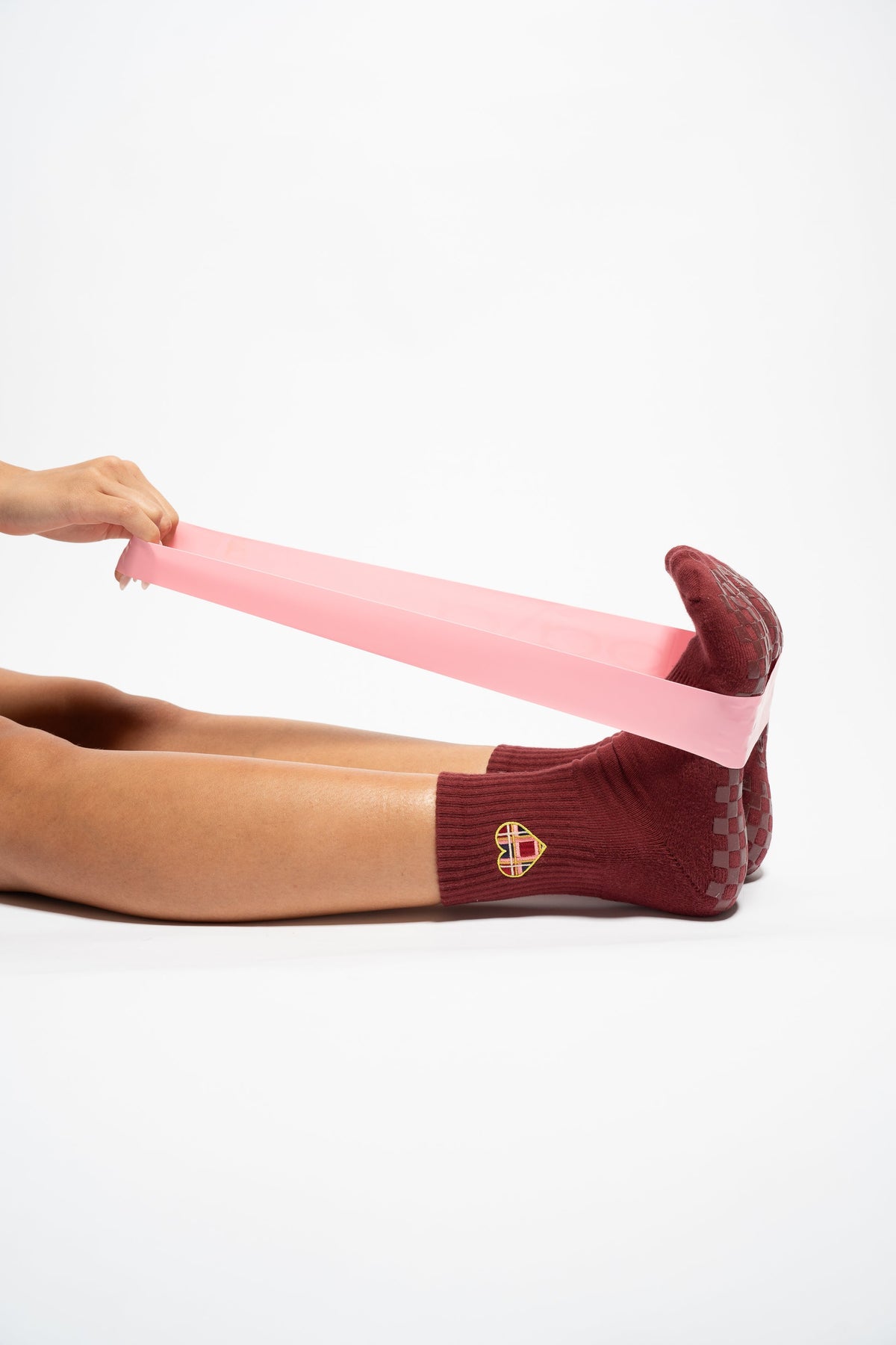 Lifestyle image of The Sweetheart burgundy grip socks