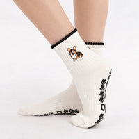 Tri Color Corgi Grip Sock worn with paw-print grip soles visible